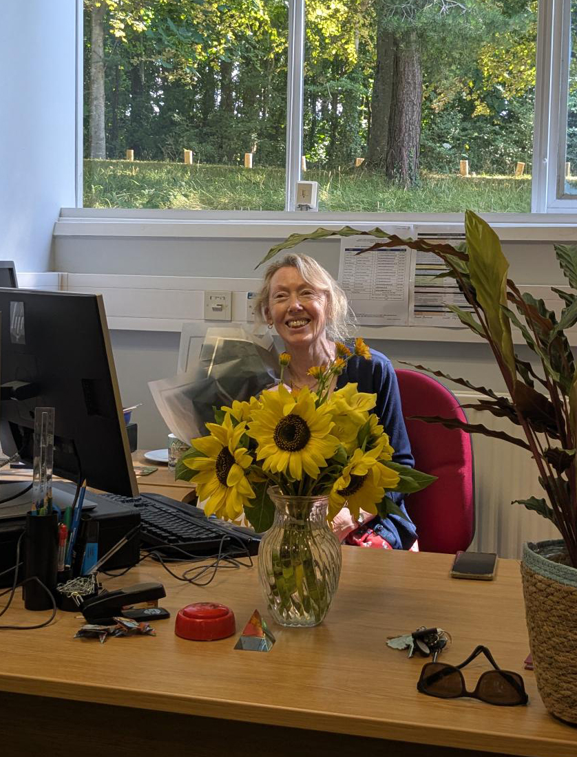 Shirley with her retirement gifts and flowers